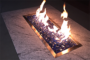 Wisconsin White Granite Fire Table at night